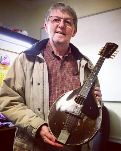 Artisan Luthiers customer with a newly restored, family heirloom, Gibson A-style mandolin, circa 1910.